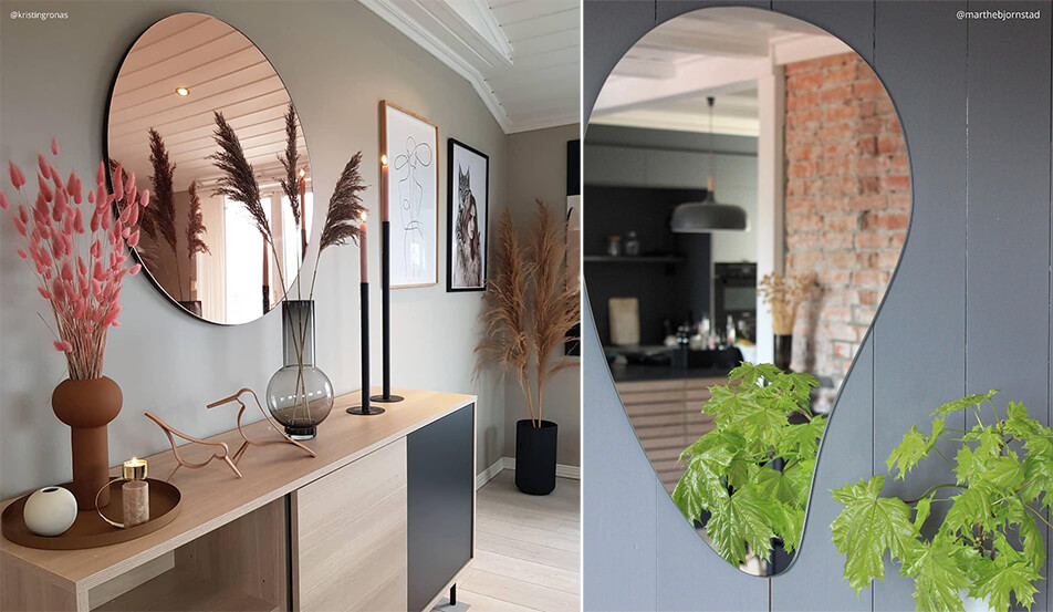 Apvalus veidrodis rožinio aukso spalvos prieš pilką sieną - lašo formos veidrodis prieš pilką sieną